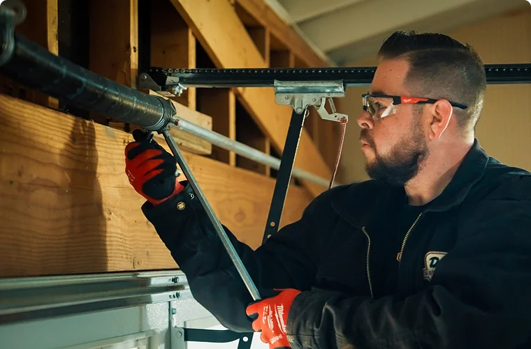 technician deciding whether to repair or replace garage door springs